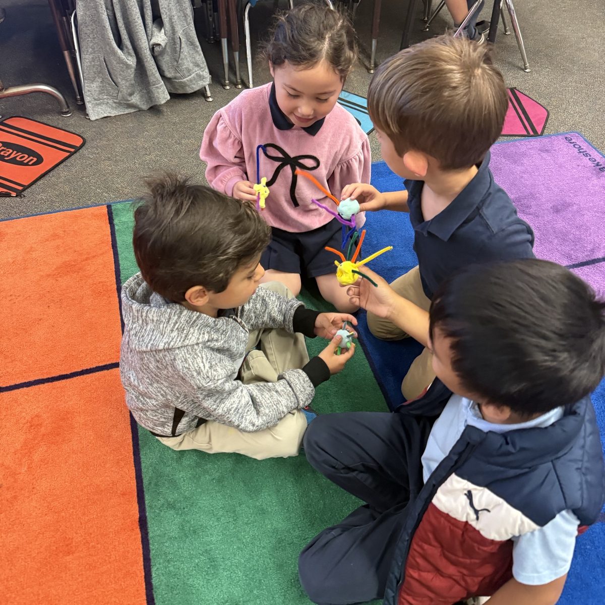 Children comparing the pipe-cleaner germ models they built