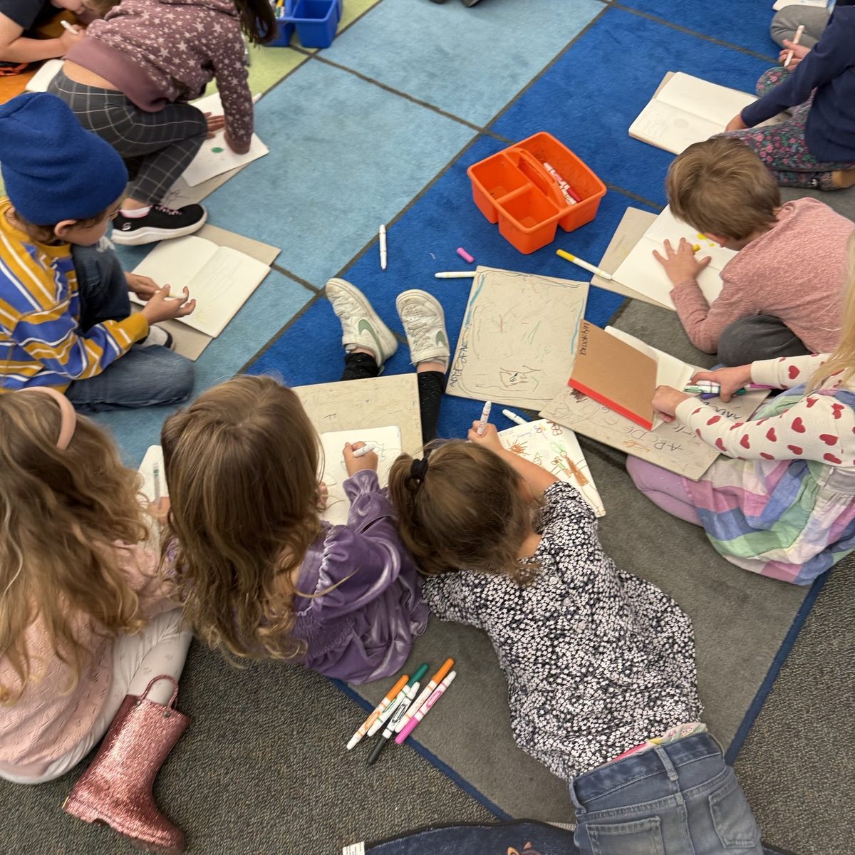 A classroom of children drawing during a health workshop